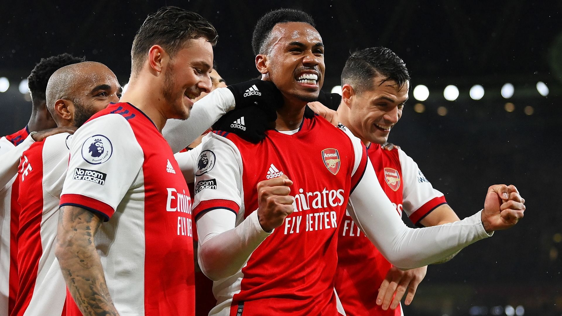 Arsenal' players celebrating a goal in front of their fans